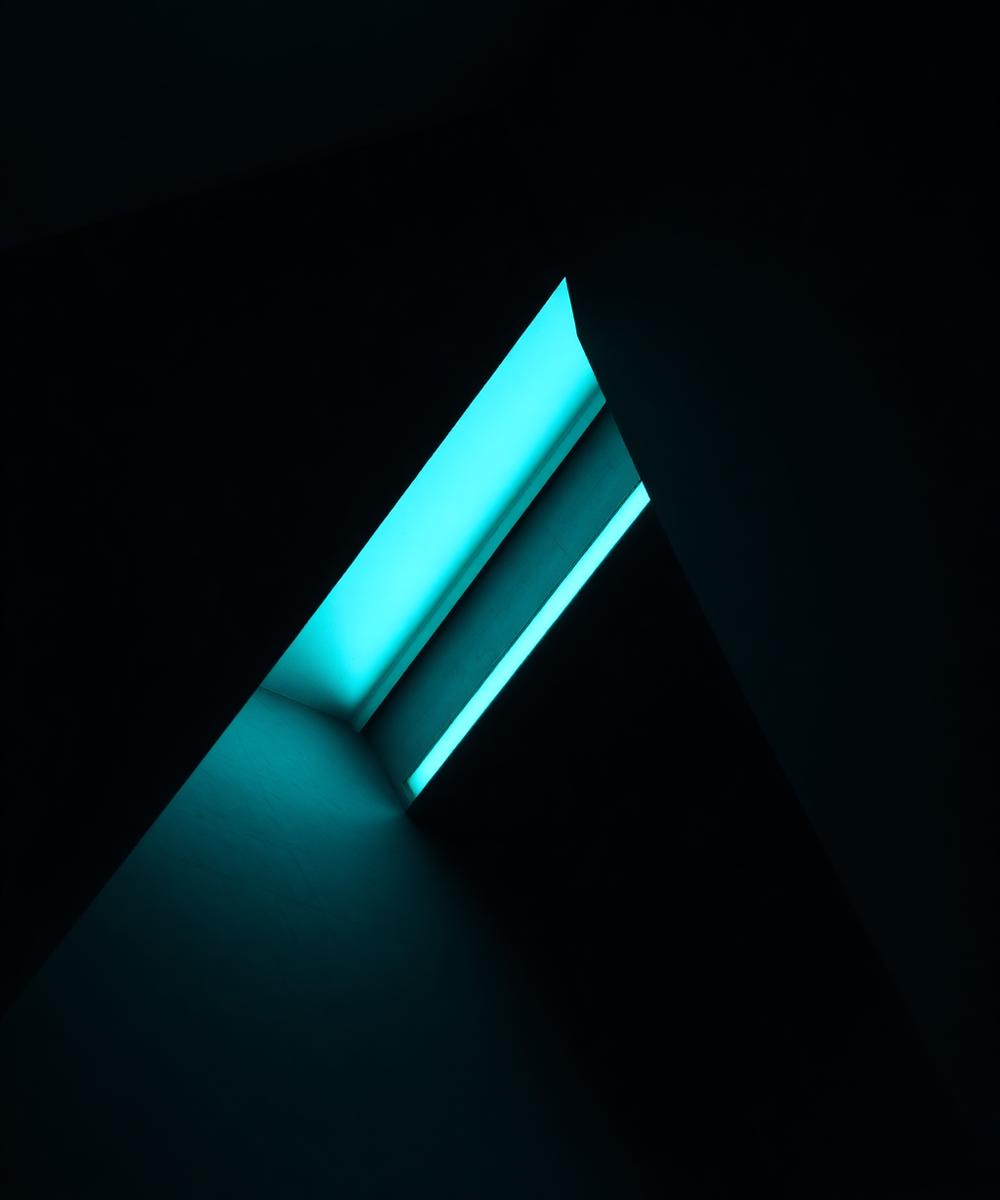 Dark angular architectural detail with a teal light line