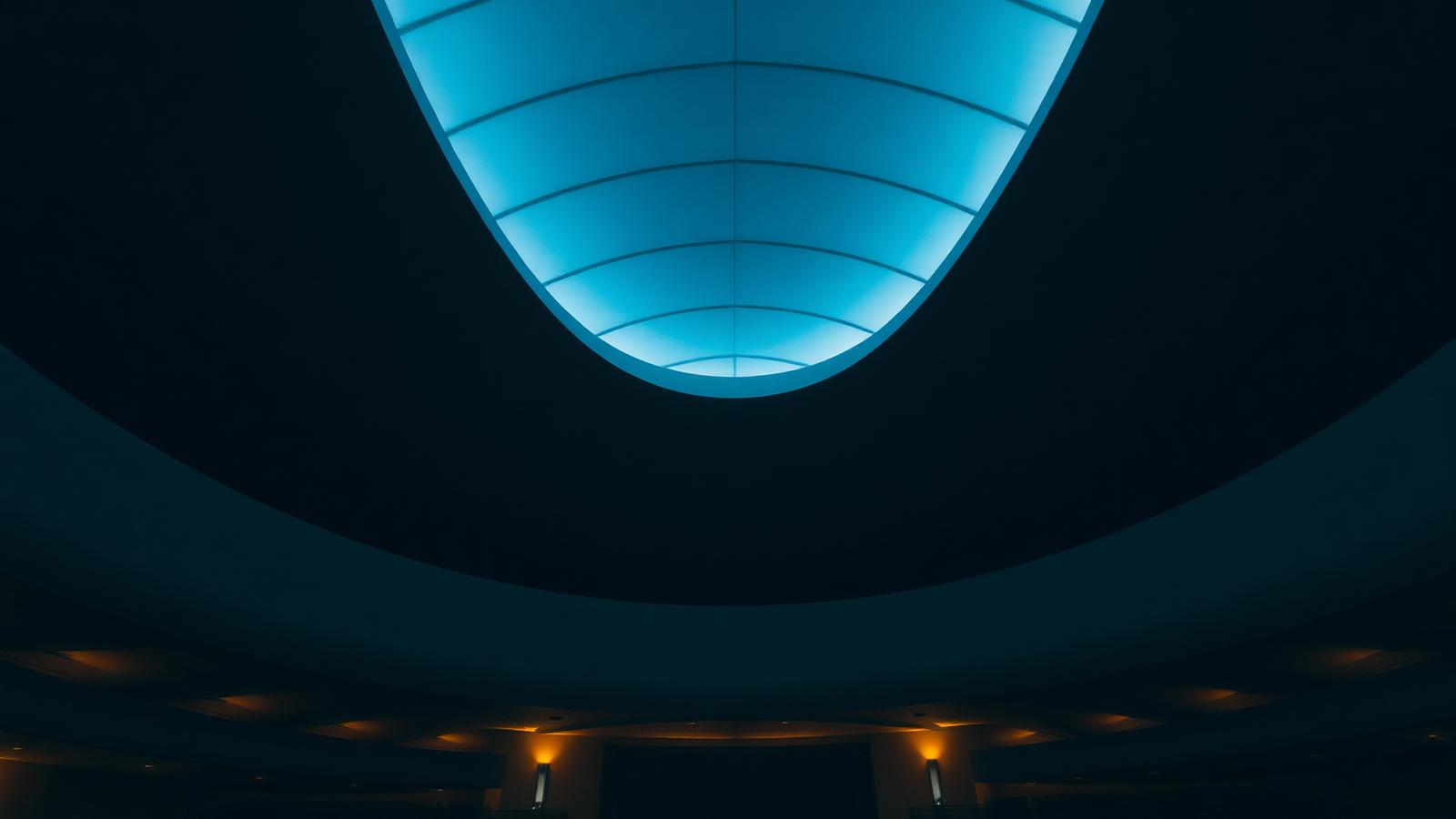 Curved architectural ceiling detail with a lit skylight
